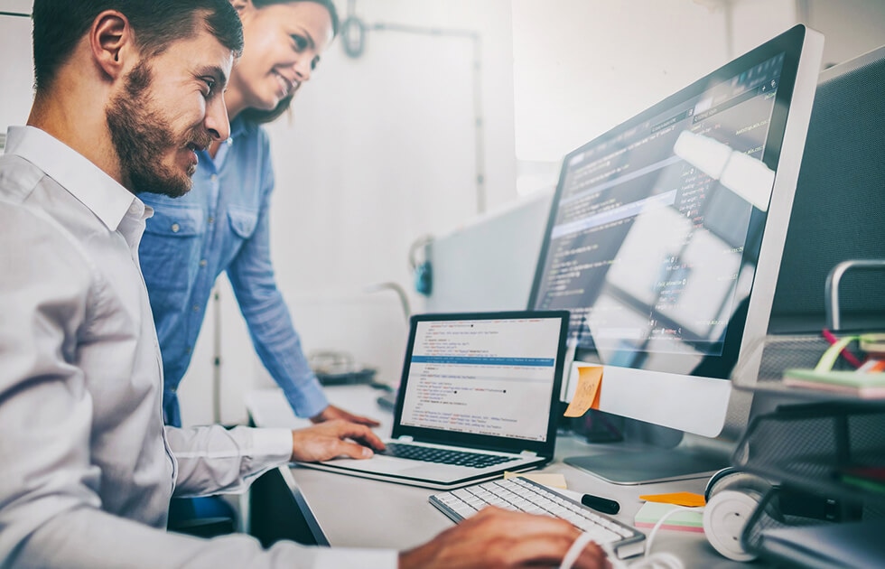 Technology professionals working on the computer